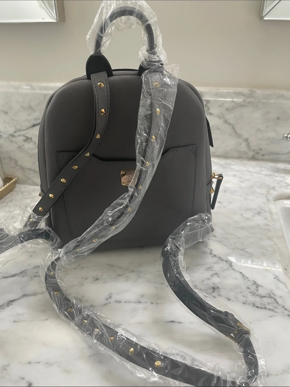 MCM Small Leather Backpack in Dark Gray with Gold Hardware